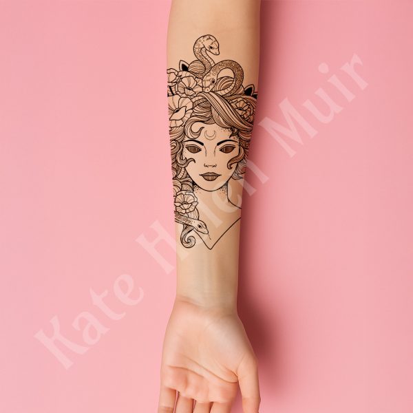 Forearm tattoo mock-up of a Medusa design on a pink background.